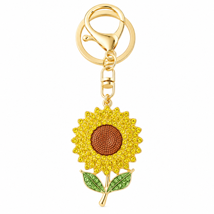 A rhinestone sunflower keychain featuring yellow and brown crystals on a gold-tone clasp and ring.
